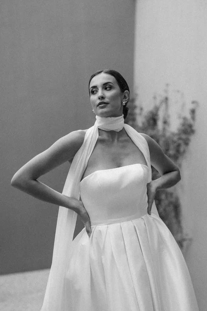 Bride in a strapless gown with a chiffon scarf at her neck