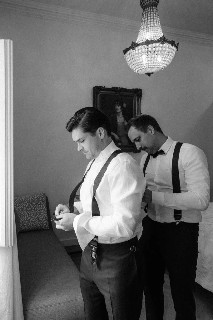 Groom being helped into his braces before the ceremony