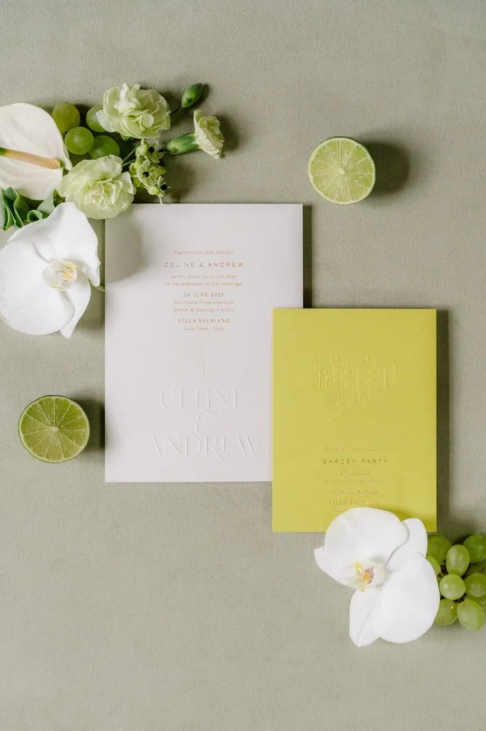 Wedding invitation suite styled with white orchids and sliced limes