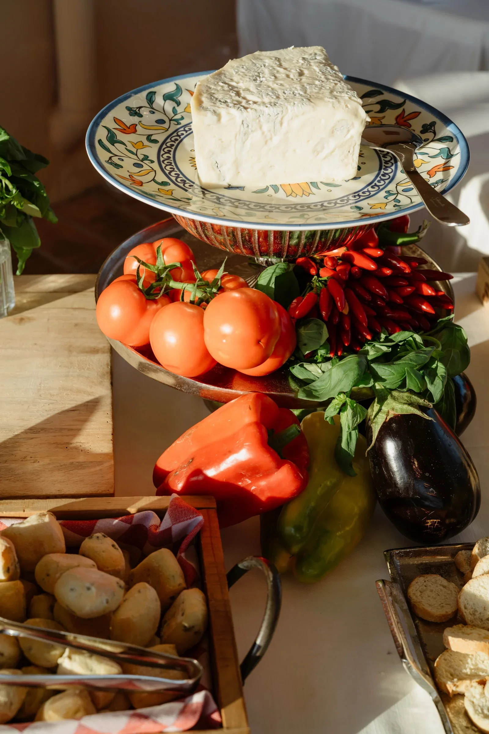 Antipasti stand with a wheel of cheese, tomatoes, peppers and aubergines at the welcome dinner