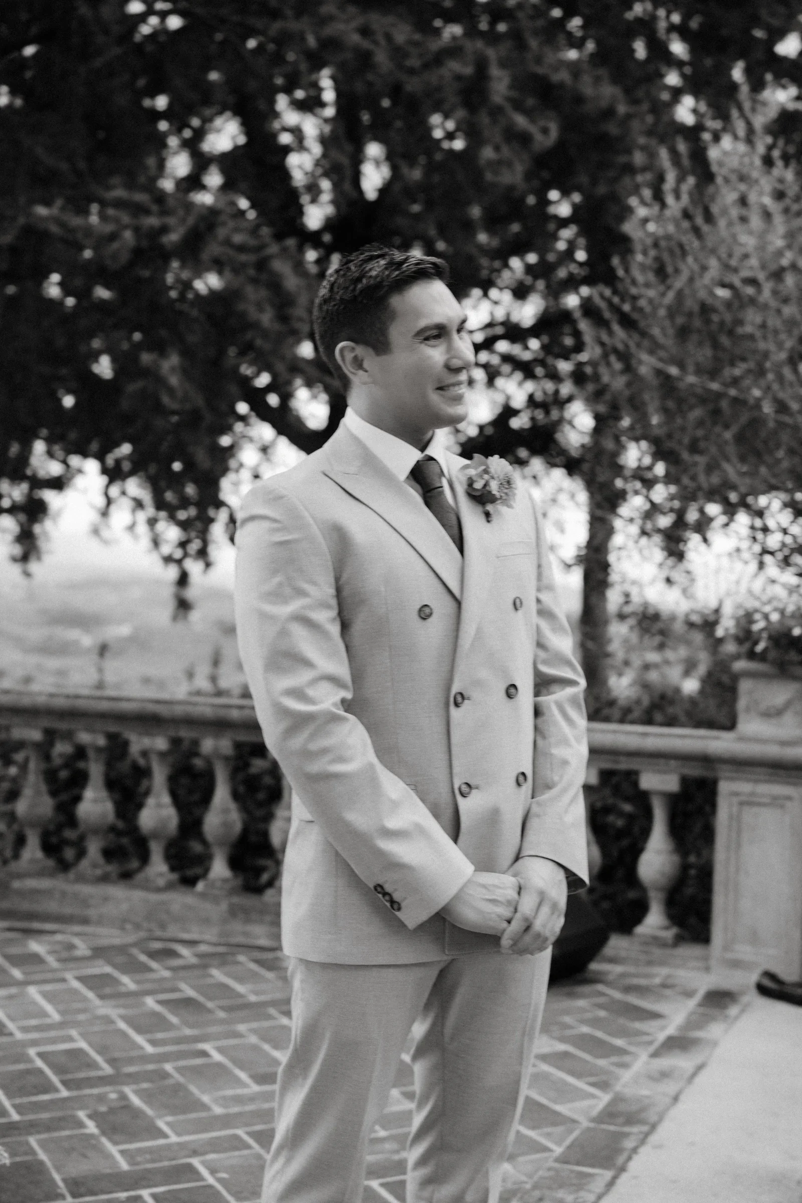 Black and white portrait of the groom waiting at the top of the aisle