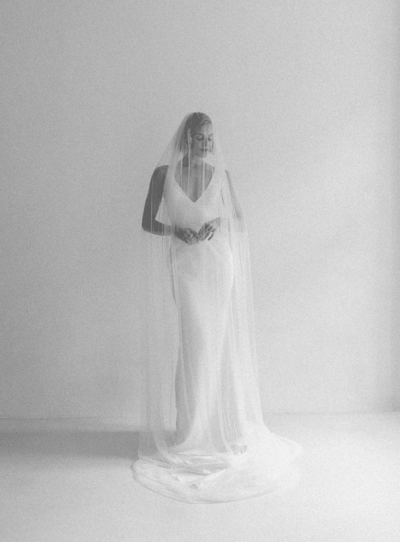 Bride in a long veil in soft, bright daylight — editorial wedding photography by Jakob Resch