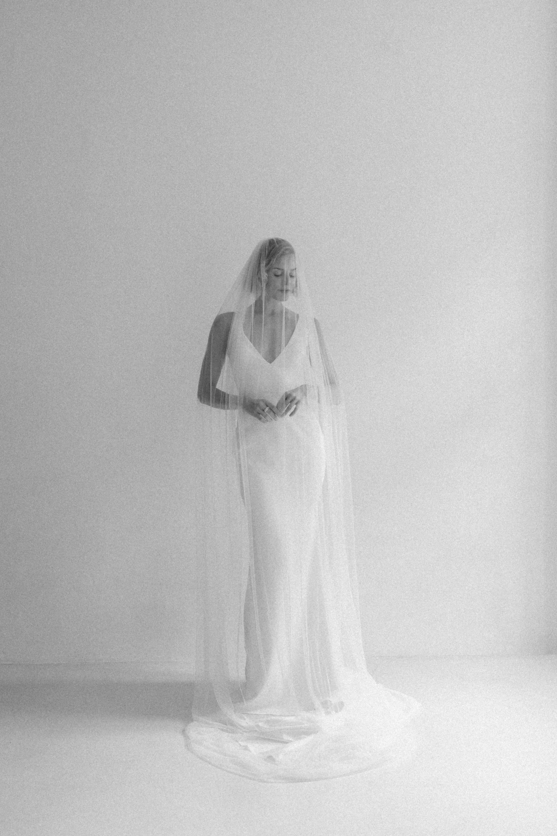 Bride in a long veil in soft, bright daylight — editorial wedding photography by Jakob Resch