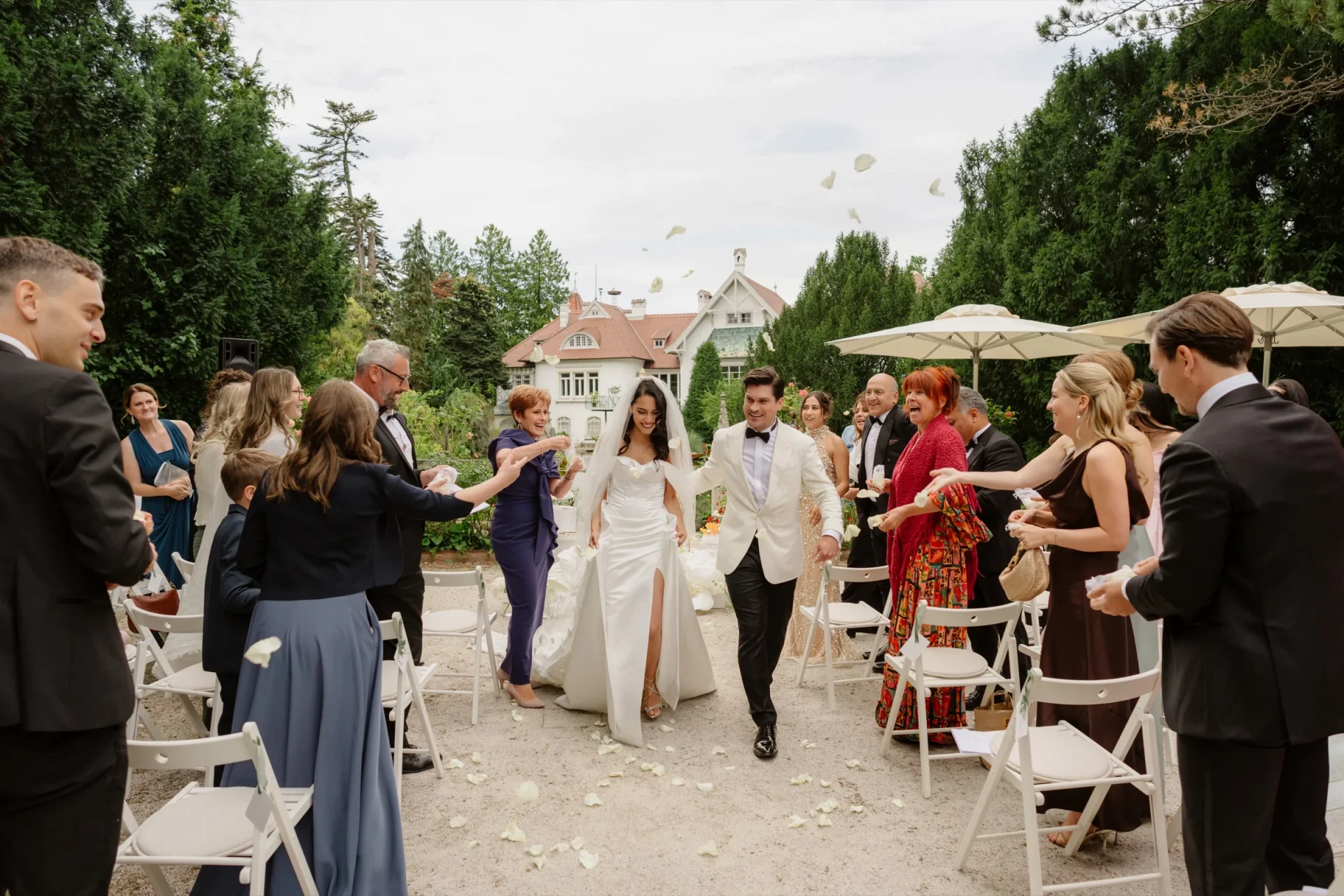 Bride and groom walking up the aisle past applauding guests