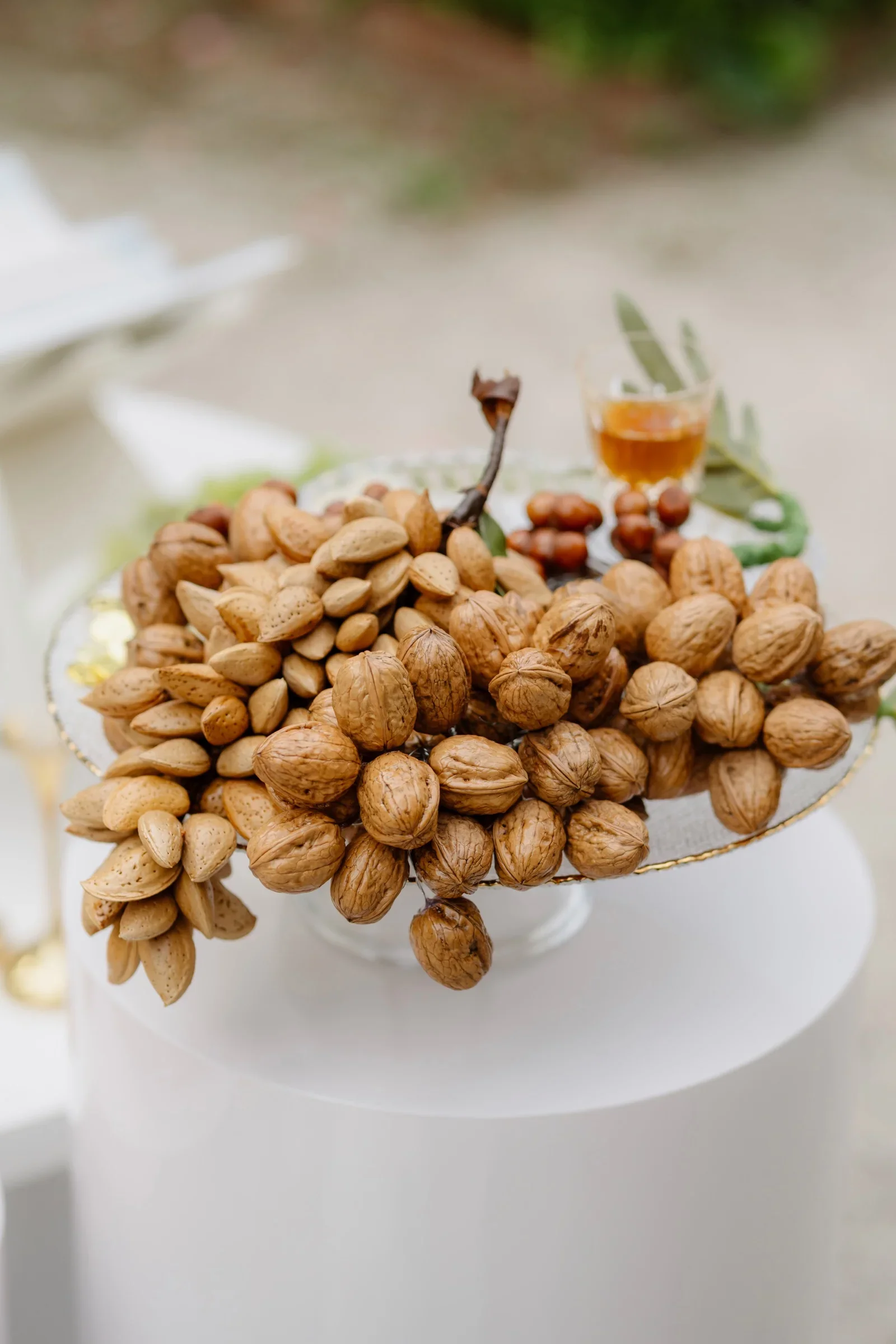 Bowl of pistachios and nuts on a white pedestal