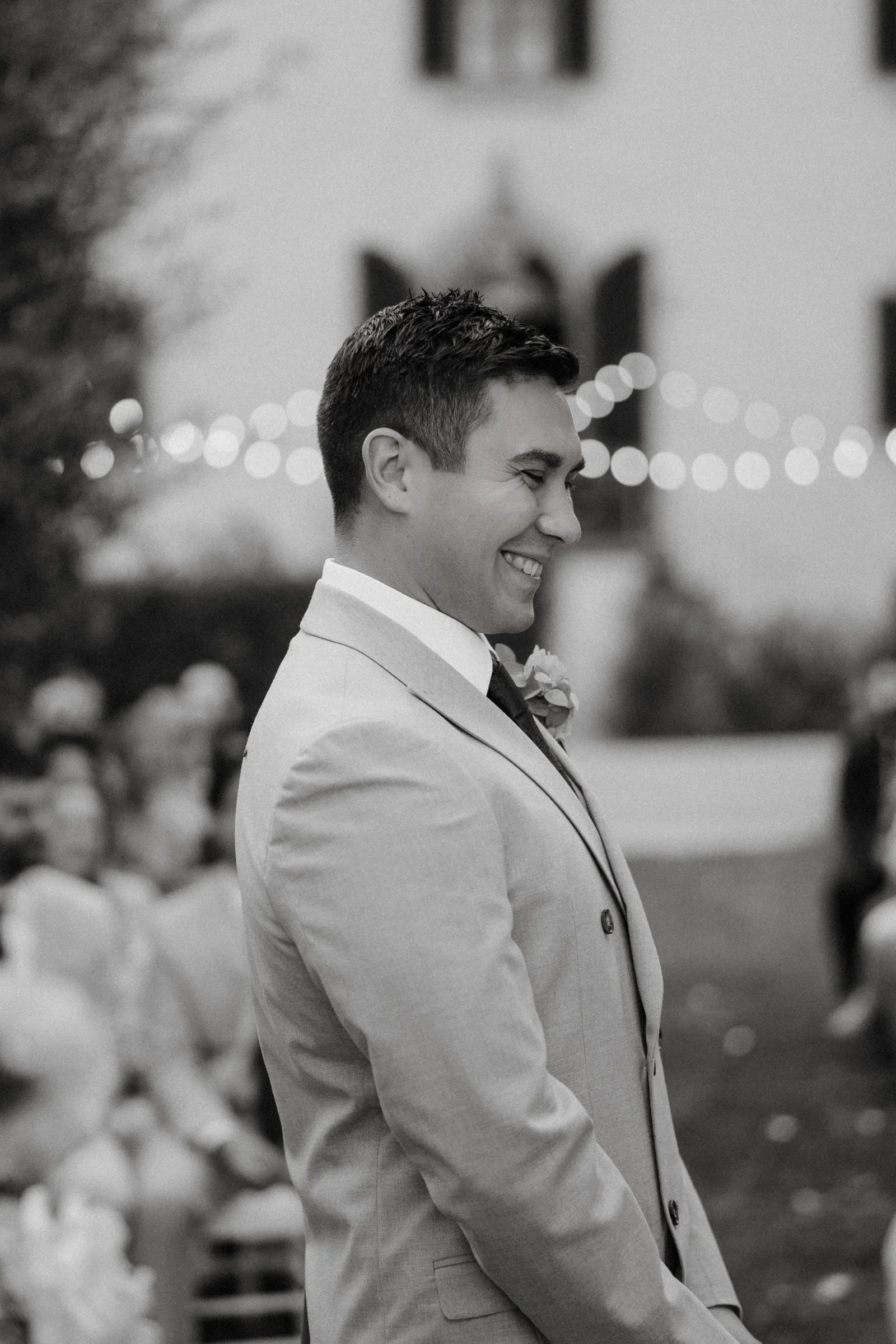Black and white: the groom turning to watch the bride come towards him