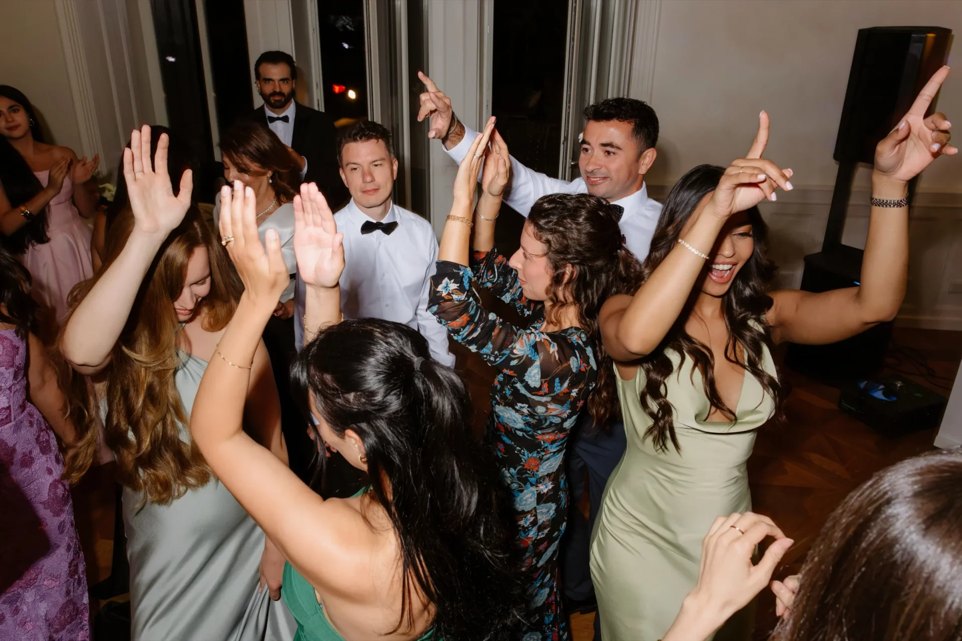 Guests dancing with raised arms on the dance floor