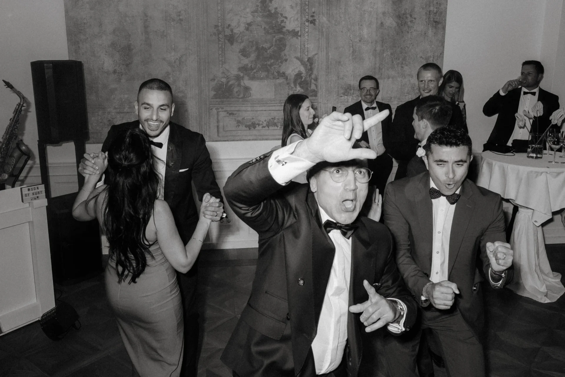 Guests dancing and cheering on the dance floor, black and white