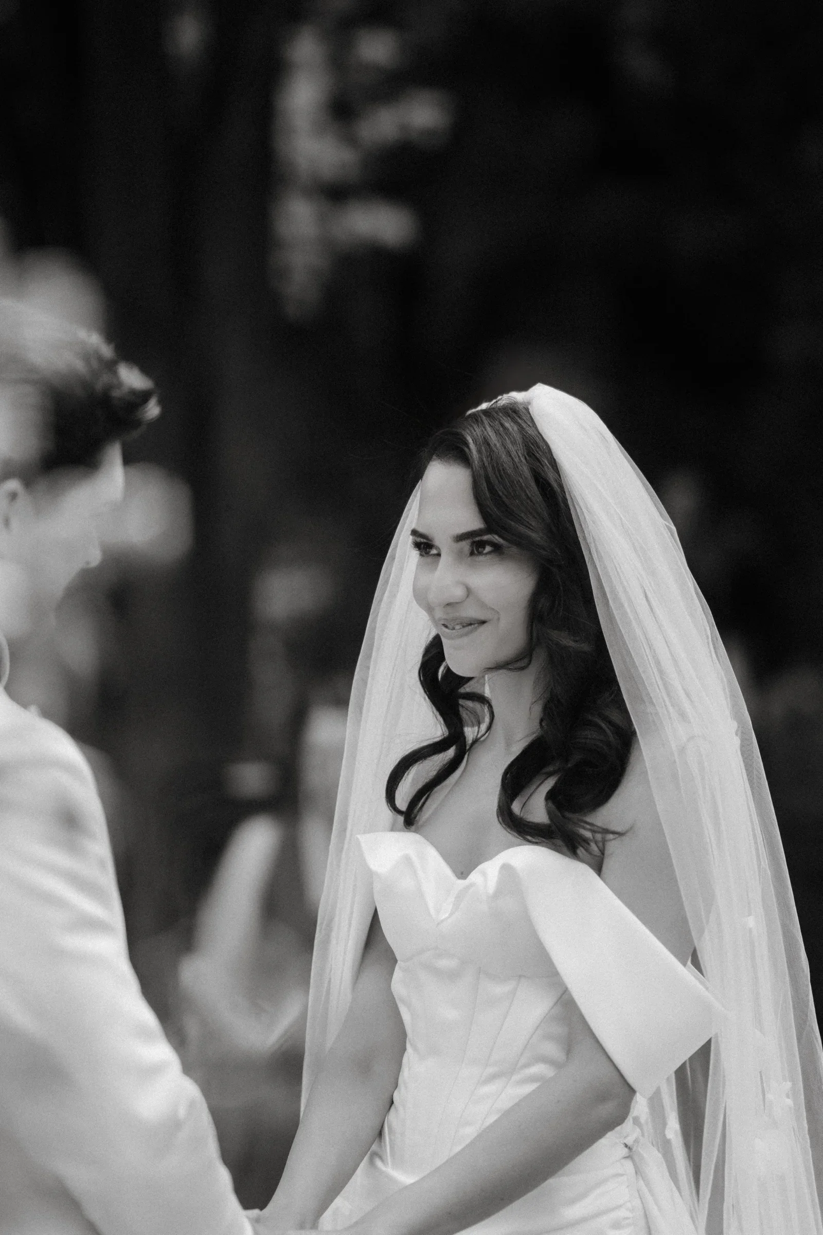 Black and white portrait of the bride in a veil and strapless gown